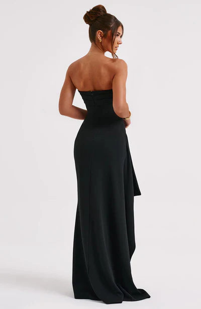 Robe de soirée noire bustier avec une longue jupe fluide vue de dos.